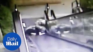 Moment OAP couple tumble down escalator before being rescued [upl. by Eerolam471]